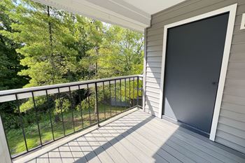 The view from the balcony of a home with a large screen door